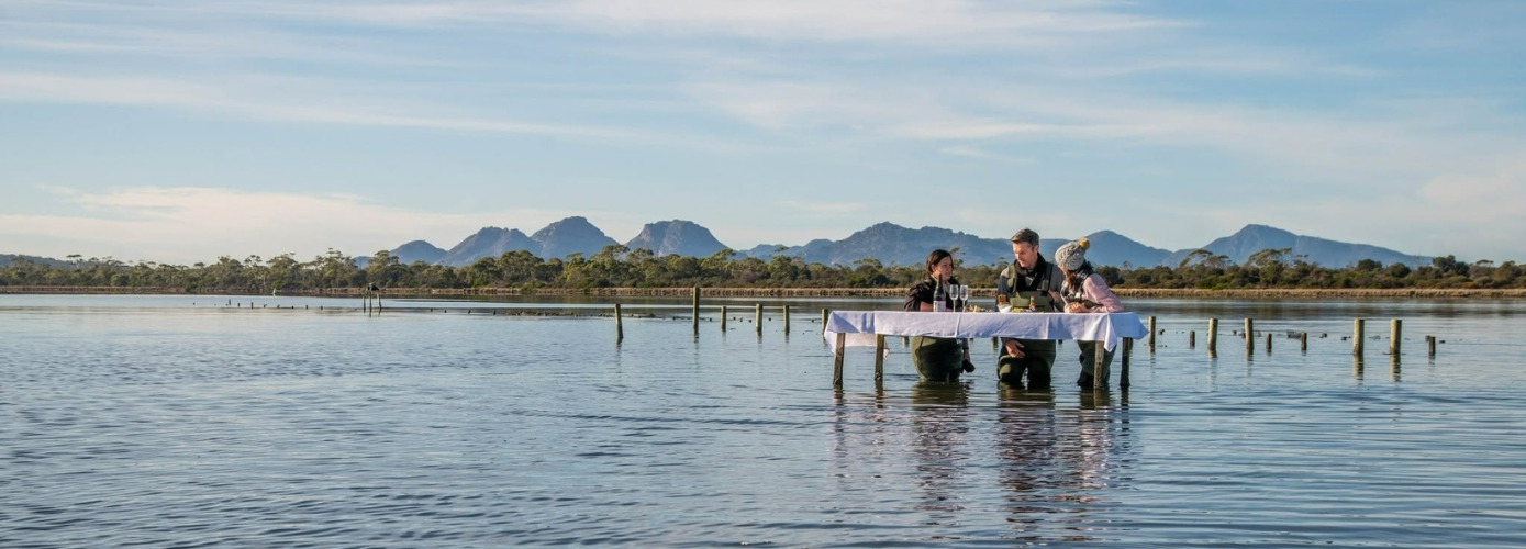Honeymooners in Tasmania, Australia, enjoy the oyster experience at Saffire Freycinet | Image credit: Saffire Freycinet